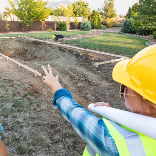 pool contractor looking over pool build