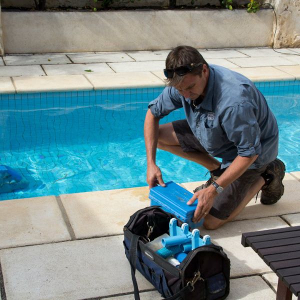 pool service guy cleaning a pool